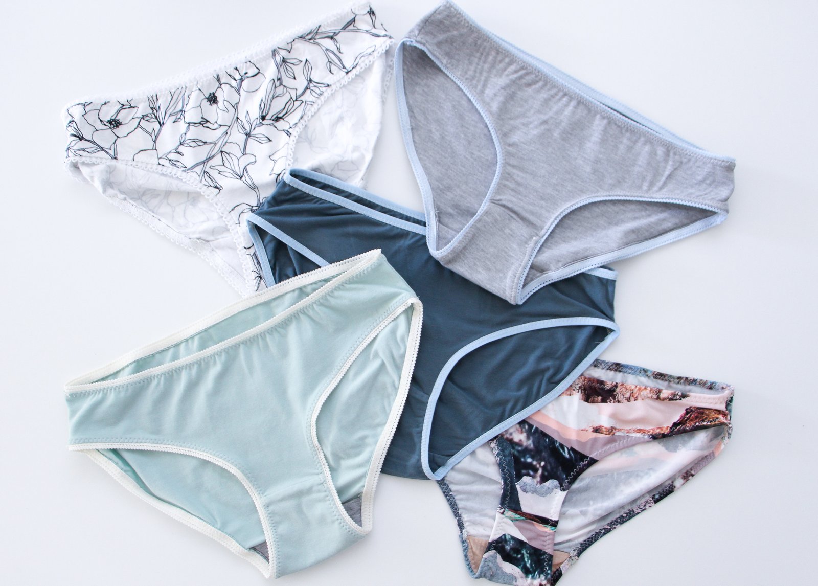 Five pairs of handmade Acacia underwear in floral, grey, navy, sage and printed fabrics